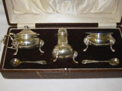 Appraisal: A THREE PIECE CONDIMENT SET of bellied form with blue