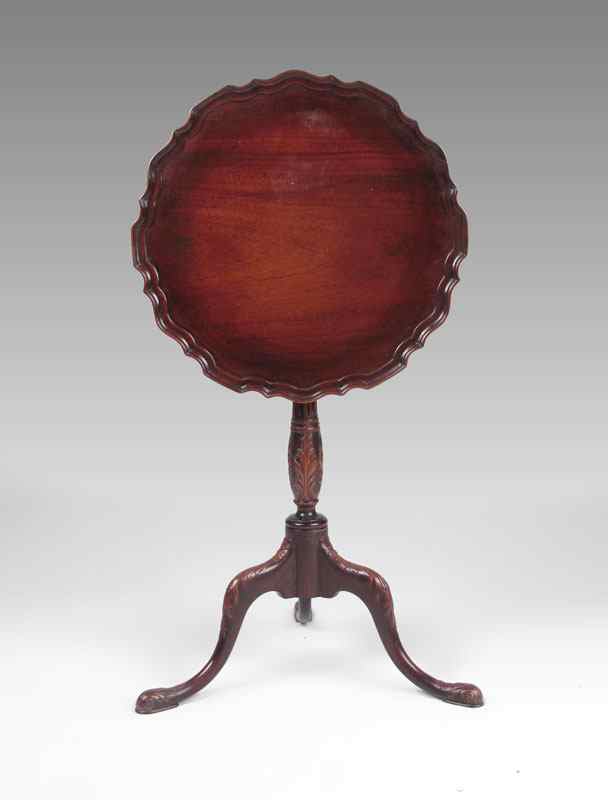 Appraisal: CARVED PIECRUST TILT TOP CANDLE STAND Mahogany with shaped piecrust