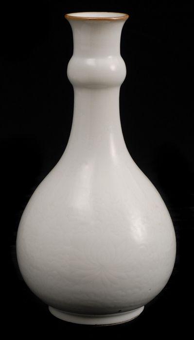 Appraisal: CHINESE IVORY-GLAZED PORCELAIN BOTTLE VASE WTH INCISED DECORATION The neck