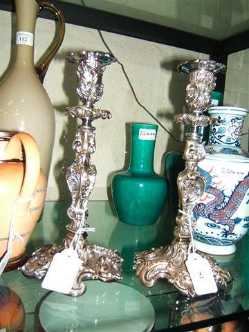 Appraisal: A pair of rococo style silver plated candlesticks high