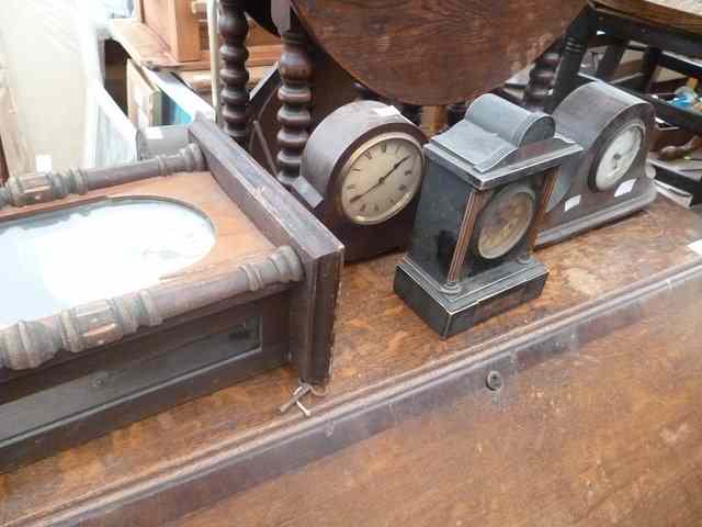 Appraisal: AN OAK CASED ANEROID BAROMETER three mantel clocks and a