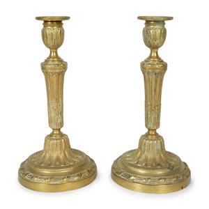 Appraisal: A Pair of Continental Brass Candlesticks th Century Height x