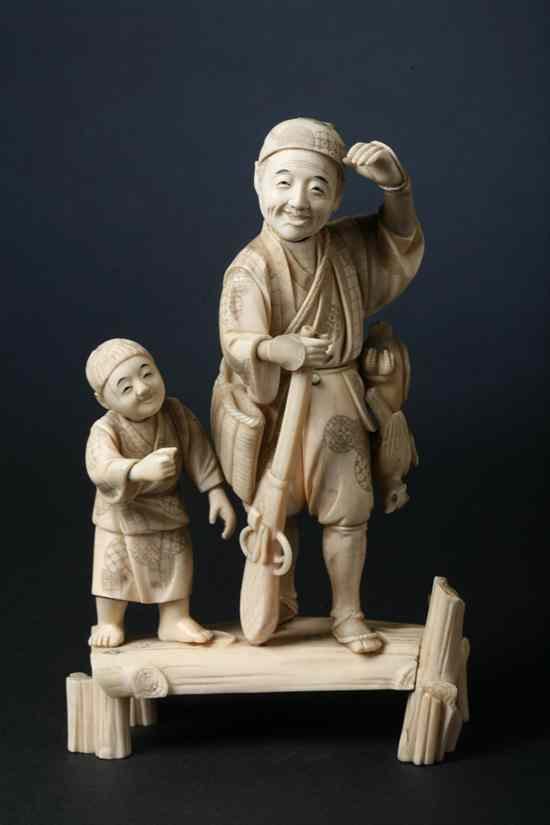 Appraisal: JAPANESE IVORY OKIMONO OF HUNTER AND YOUTH Meiji Period th