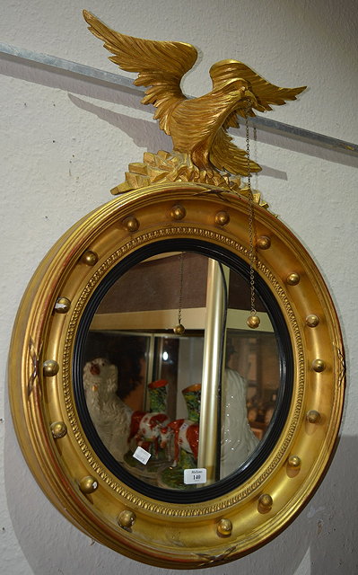 Appraisal: th Century gilt circular wall mirrorwith eagle and ball mount