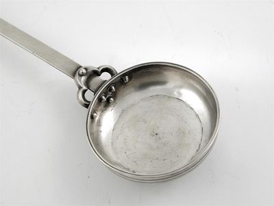 Appraisal: A Caucasian ladle with a shallow circular bowl rivetted to