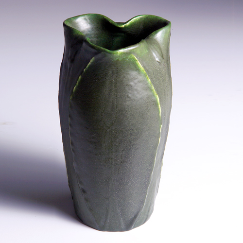 Appraisal: GRUEBY Trefoil vase with full-height buds alternating with broad leaves