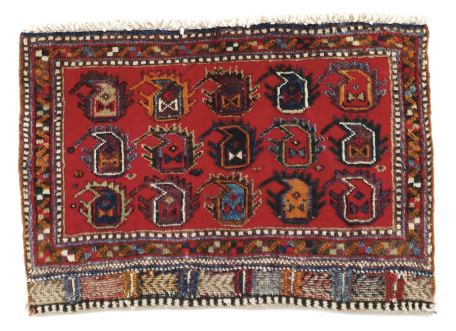 Appraisal: TRIBAL BAG FACE ORIENTAL MAT Red field having three rows