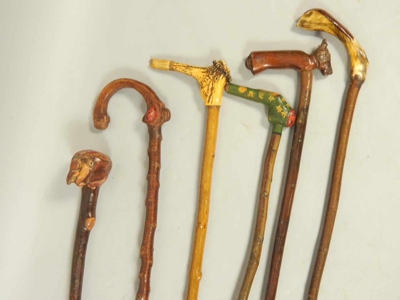 Appraisal: Walking sticks with carved figural wooden or antler handle