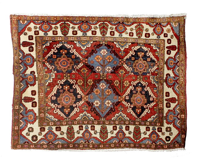 Appraisal: A Baluch cream ground rugwith multiple foliate medallions within a