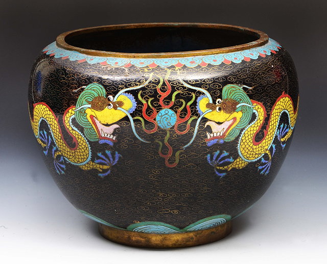 Appraisal: Chinese black ground cloisonne jardinieredecorated with dragons cm high