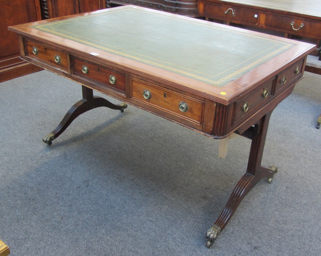 Appraisal: A th century mahogany centre writing table on trestle end