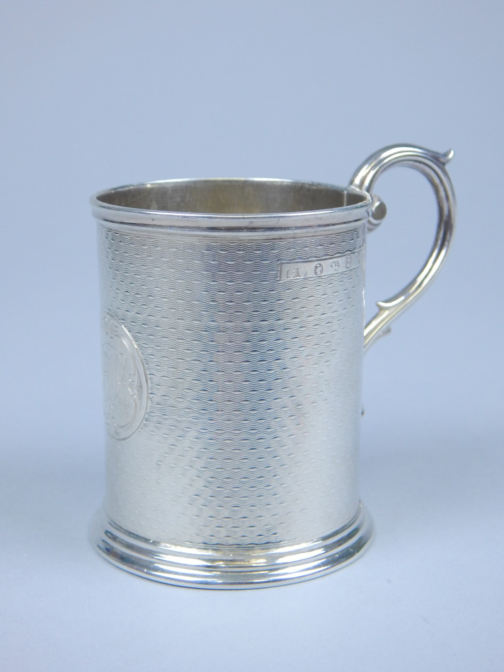 Appraisal: A Victorian engine turned silver cylindrical christening mug the circular