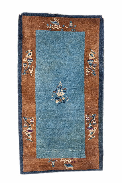 Appraisal: A CHINESE BLUE GROUND RUG with a simple foliate design