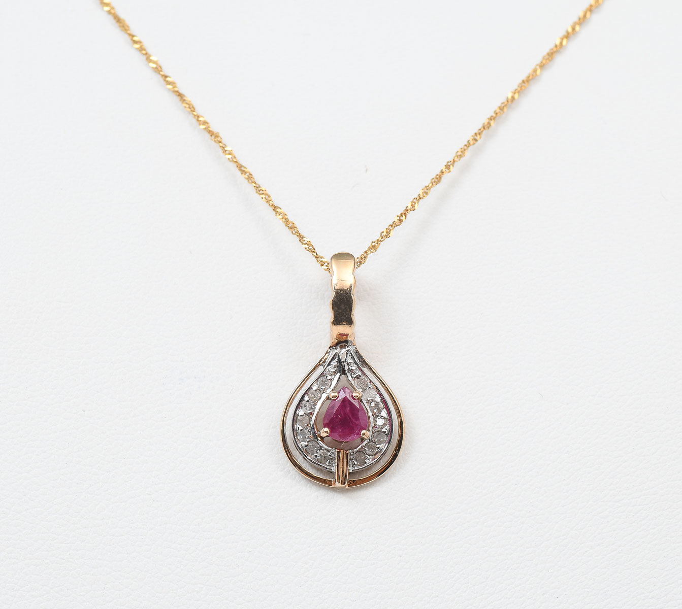 Appraisal: K RUBY AND DIAMOND PENDANT K yellow gold pendant contains