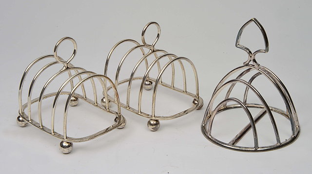 Appraisal: A PAIR OF SILVER FOUR DIVISION TOAST RACKS with ball