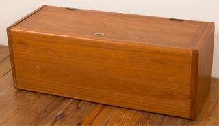 Appraisal: Teakwood Rolling Trunk Modern teakwood trunk with sleek rounded edges