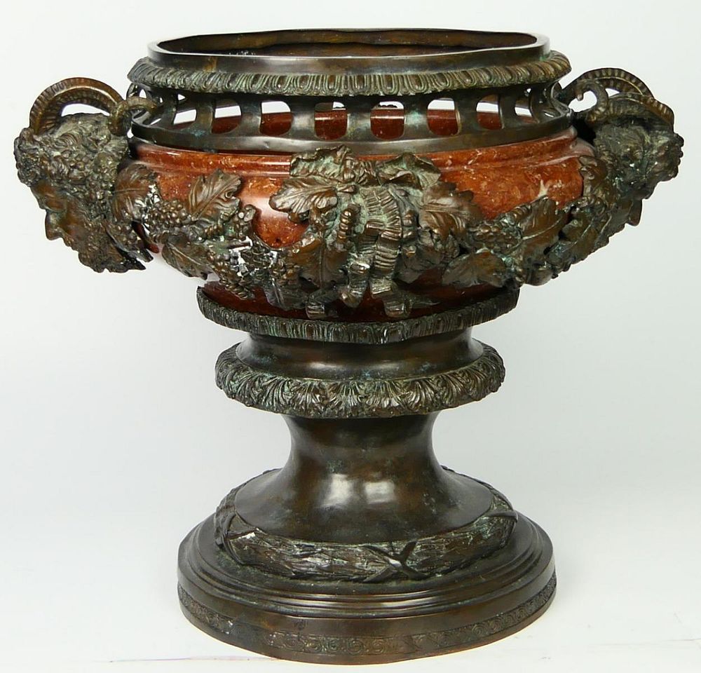 Appraisal: LARGE BRONZE ROUGE MARBLE SATYRS URN A large urn planter