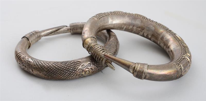 Appraisal: TWO ENGRAVED METAL BRACELETS WITH COILED ENDS The one with