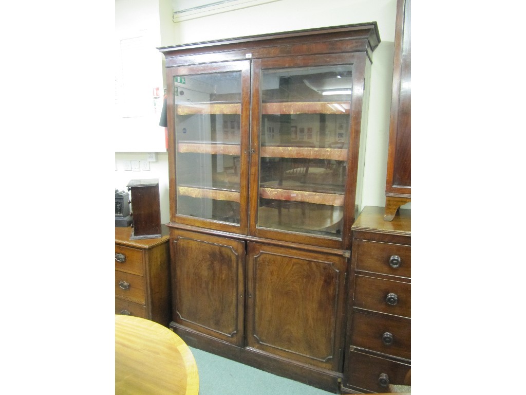 Appraisal: th century mahogany bookcase on cupboard base