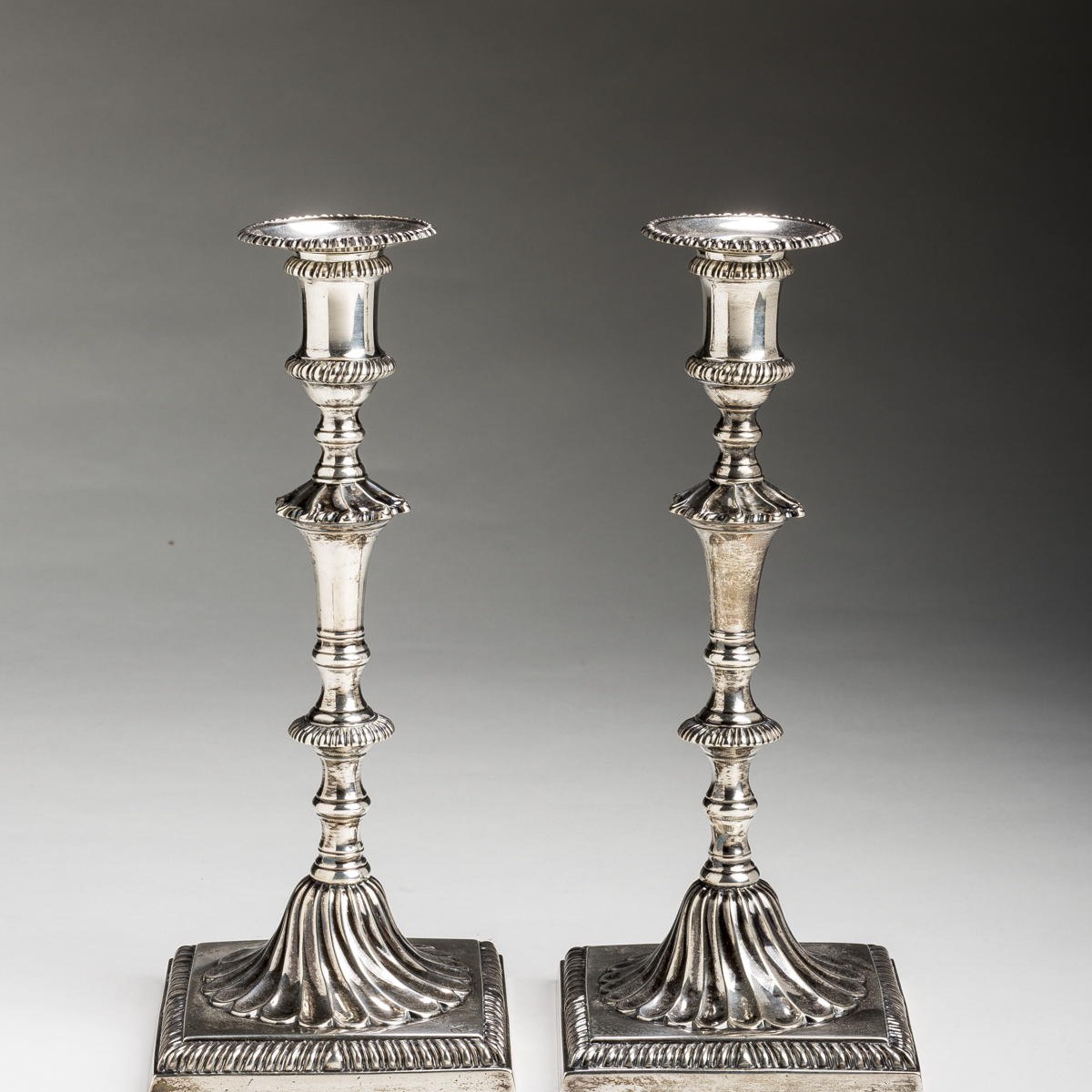 Appraisal: PAIR OF GEORGE III SILVER CRESTED TABLE CANDLESTICKS JOHN CARTER