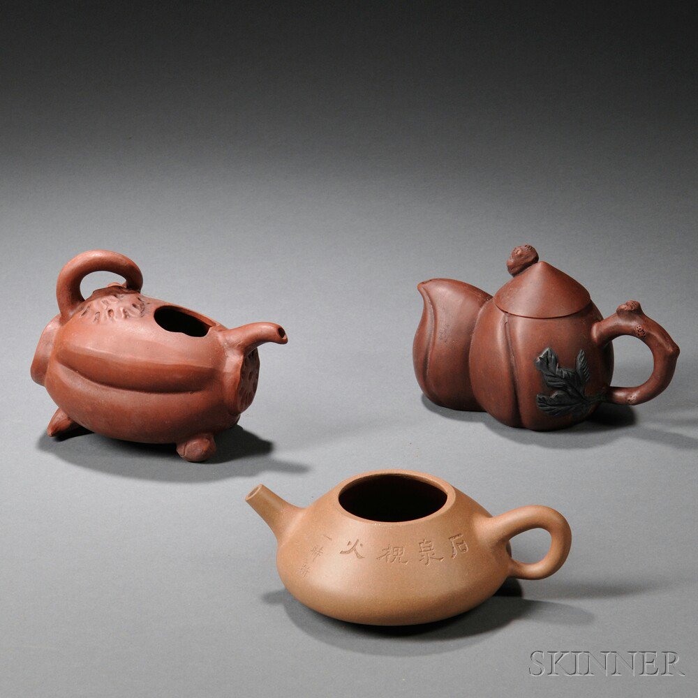 Appraisal: Three Yixing Teapots China a lotus root-inspired pot with molded