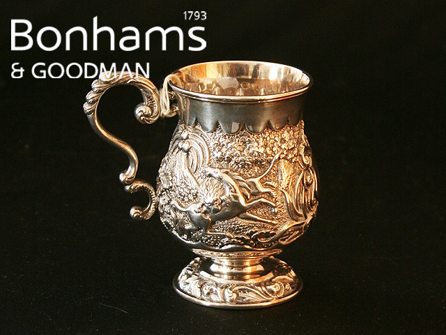 Appraisal: A Sterling silver christening mug with repousse decoration of fighting