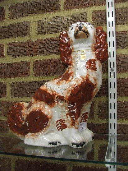 Appraisal: A STAFFORDSHIRE POTTERY SEATED SPANIEL with padlock and chain high