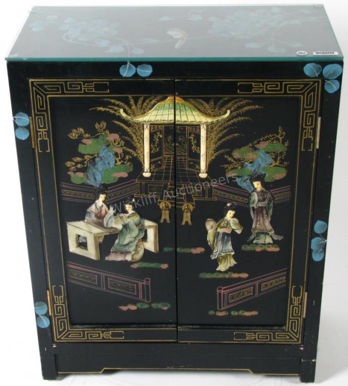 Appraisal: A black lacquer base cabinet Chinoiserie decoration with applied figural