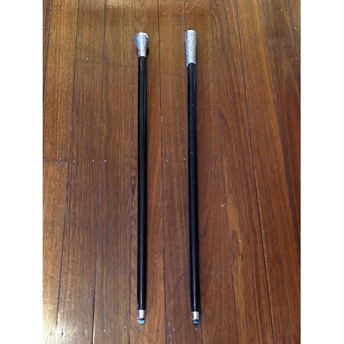 Appraisal: Two ebonized metal mounted walking sticks approx cm L and