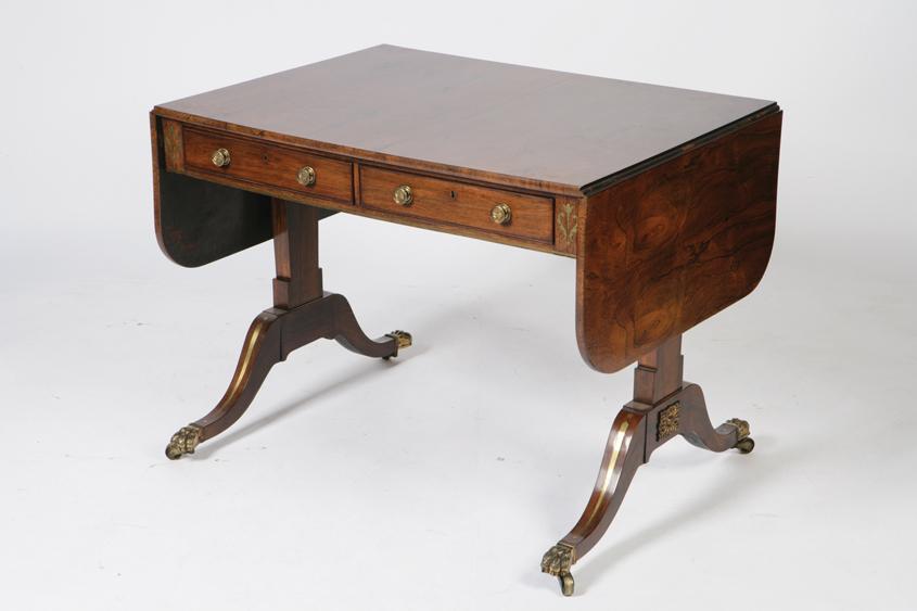 Appraisal: A REGENCY ROSEWOOD SOFA TABLE the rectangular top with twin