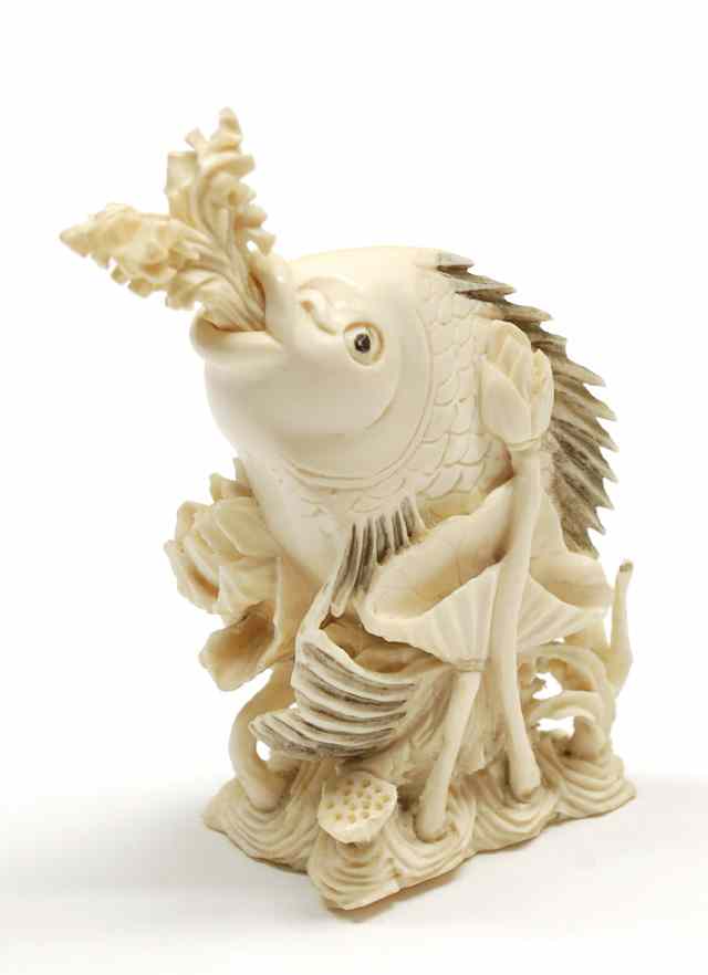 Appraisal: AN IVORY CARVED SNUFF MEDICINE BOTTLE Depicts a fish nearly