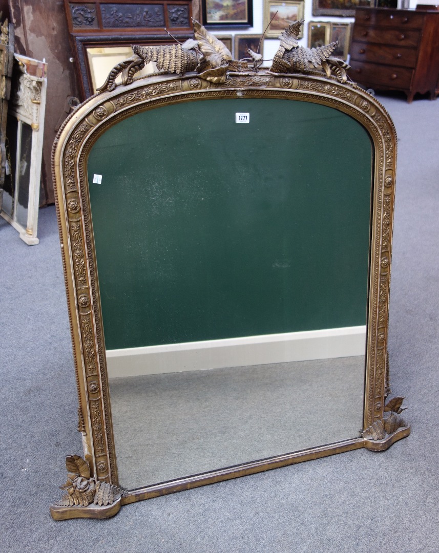 Appraisal: A th century gilt framed arch top wall mirror with