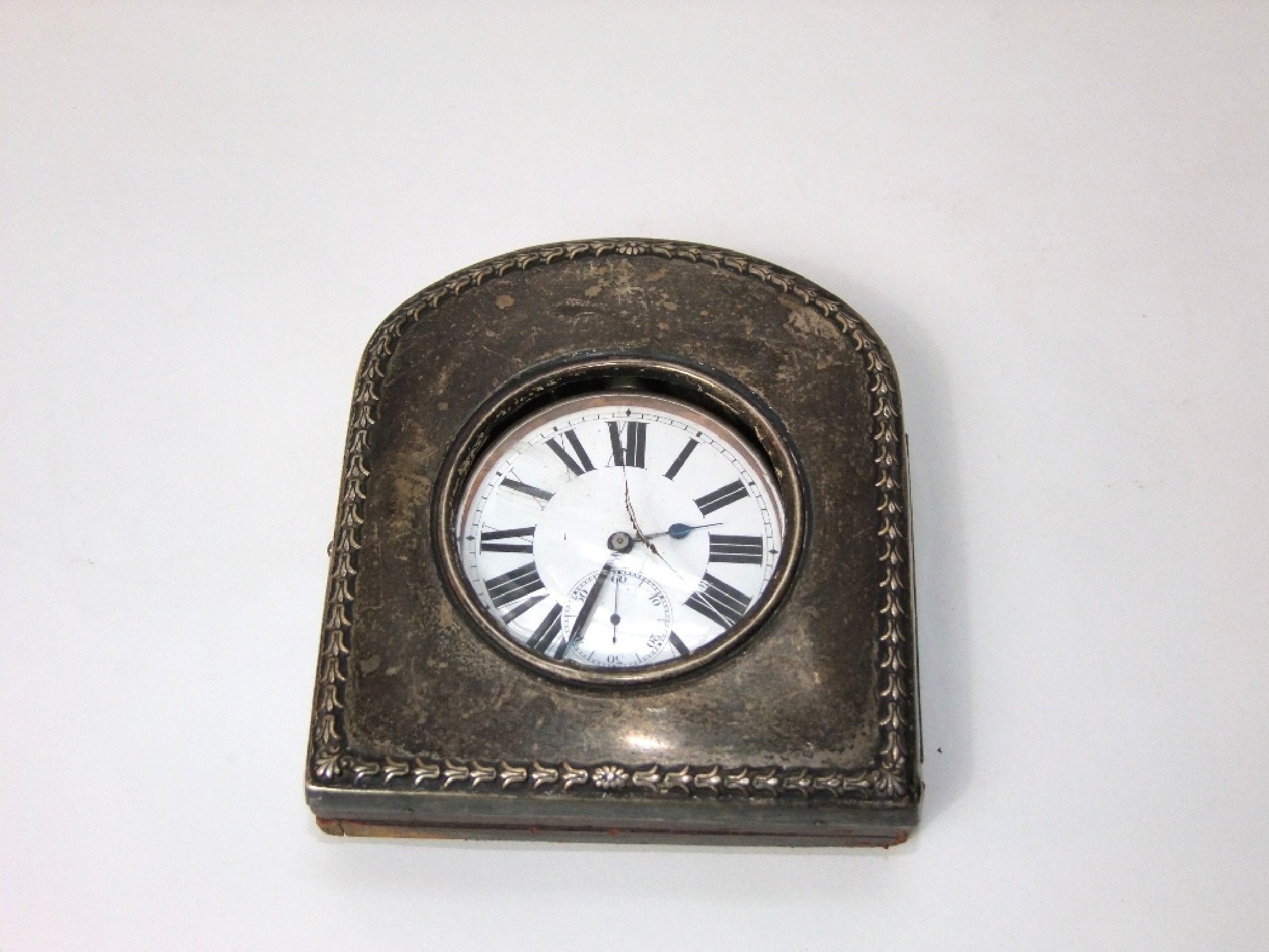 Appraisal: A silver night watch case with harebell border and leather