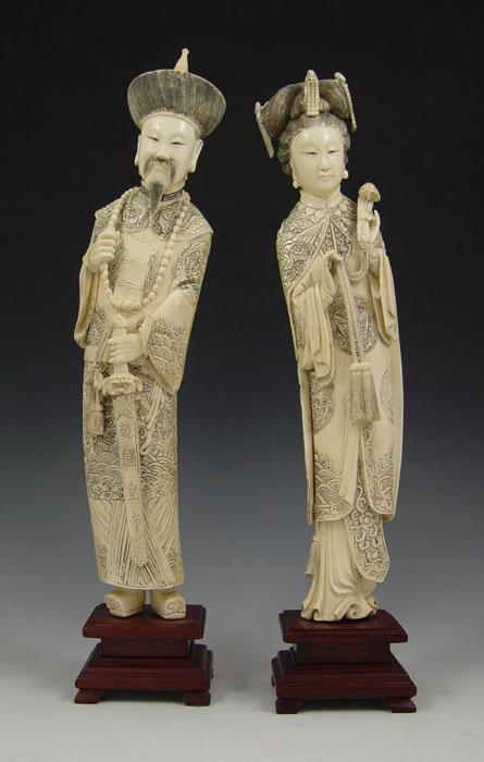 Appraisal: CHINESE CARVED IVORY FIGURES Elaborate robes and detail man and