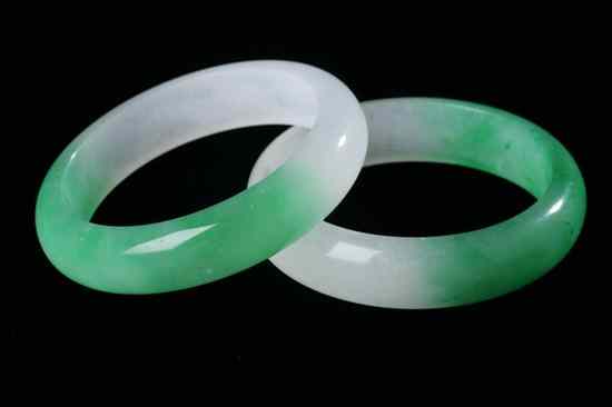 Appraisal: TWO CHINESE APPLE GREEN AND LIGHT GREY JADEITE BANGLES -