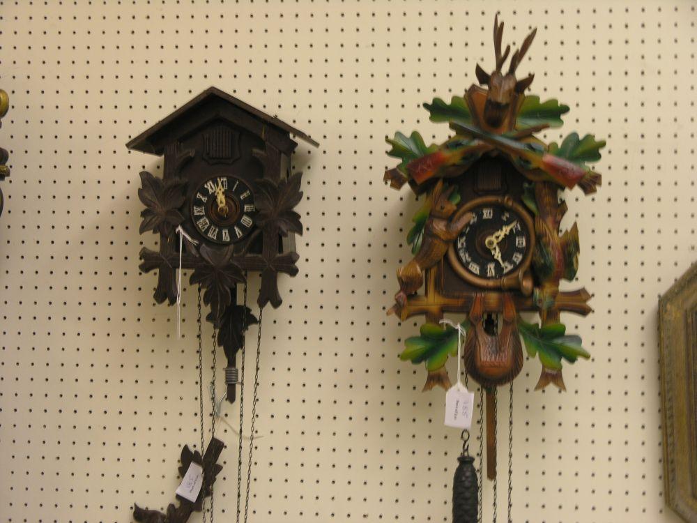 Appraisal: Two carved wood cuckoo clocks each with two weights and