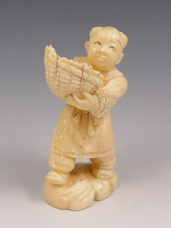 Appraisal: CARVED IVORY FIGURE OF MAN WITH BASKET OF FRUIT Signed