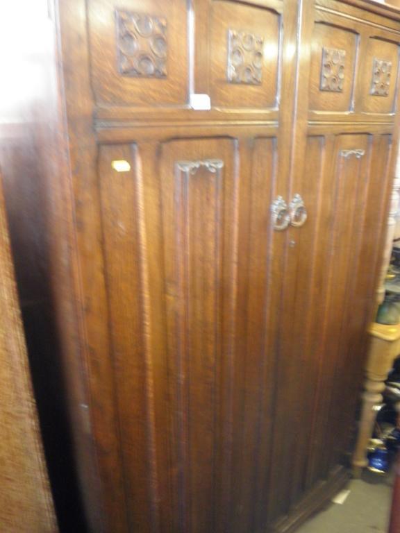 Appraisal: An oak double wardrobe with linen fold carved doors