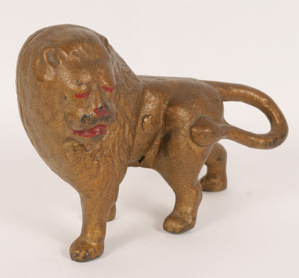 Appraisal: Cast iron doorstop full-bodied standing lion old gold paint H