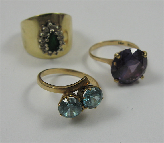 Appraisal: THREE YELLOW GOLD RINGS including a blue zircon and K