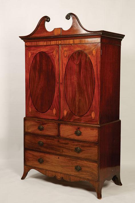 Appraisal: A GEORGE III MAHOGANY LINEN PRESS with a swan neck