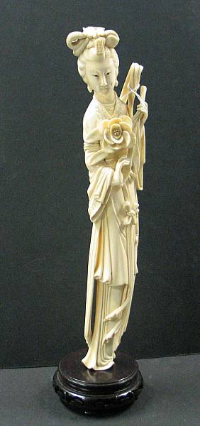 Appraisal: A carved and tinted ivory figure of a beauty Depicted