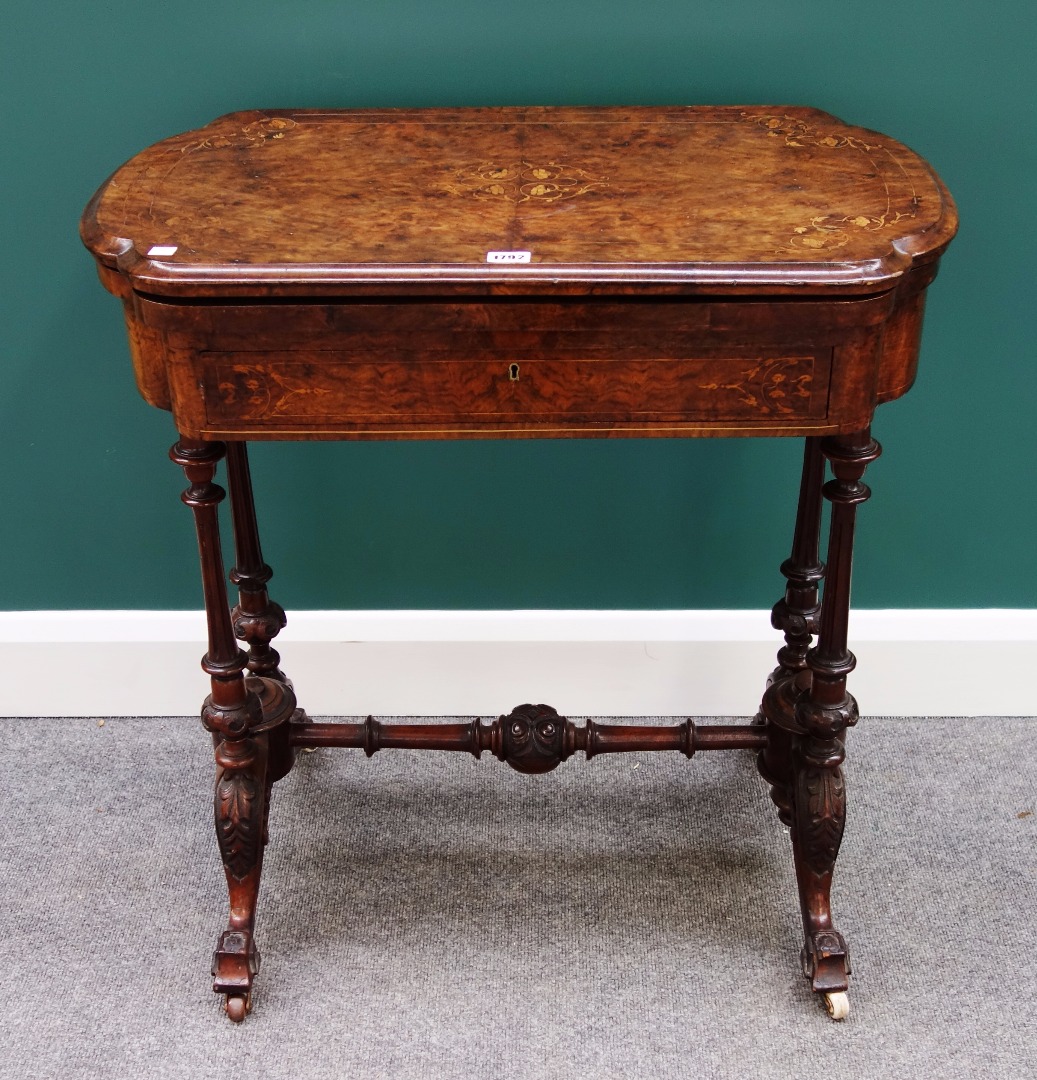 Appraisal: A Victorian marquetry inlaid figured walnut games sewing table the