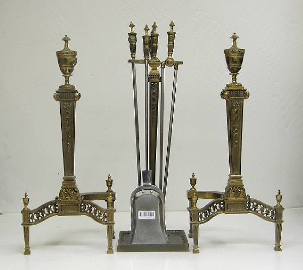 Appraisal: A pair of Neoclassical style brass andirons and matching fire