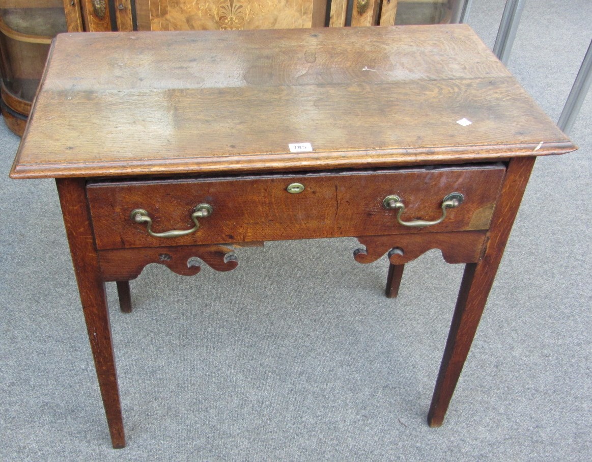 Appraisal: An th century oak lowboy with single frieze drawer on