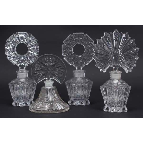 Appraisal: Four Pressed Glass Art Deco Perfume Bottles with Star Burst