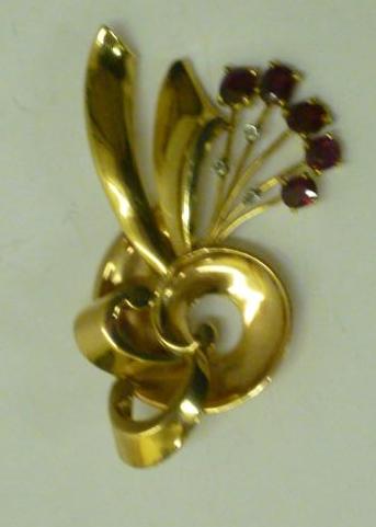 Appraisal: A RUBY AND DIAMOND COCKTAIL BROOCH modelled as a stylised