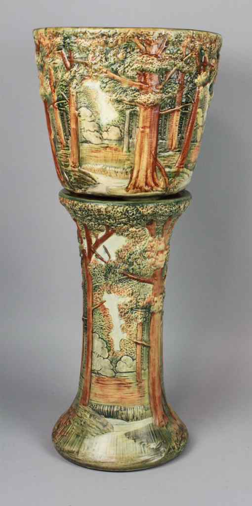 Appraisal: WELLER POTTERY FOREST PATTERN URN AND PEDESTAL decorated in continuous