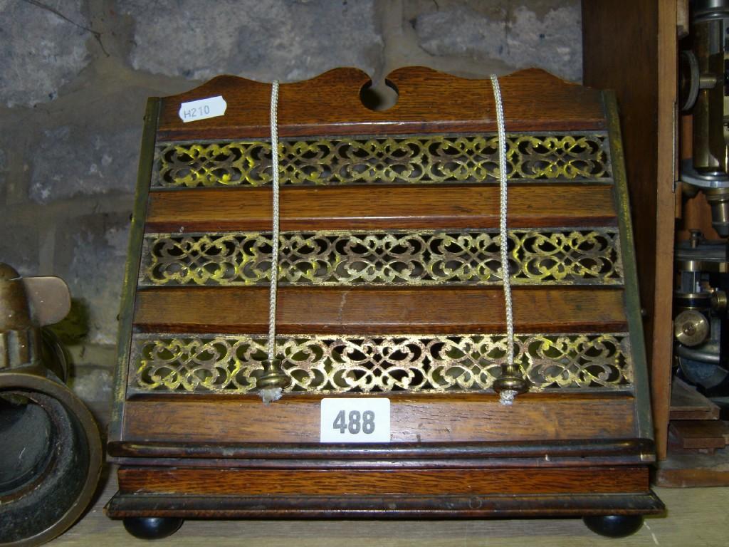 Appraisal: A th century oak adjustable music stand with pierced brass