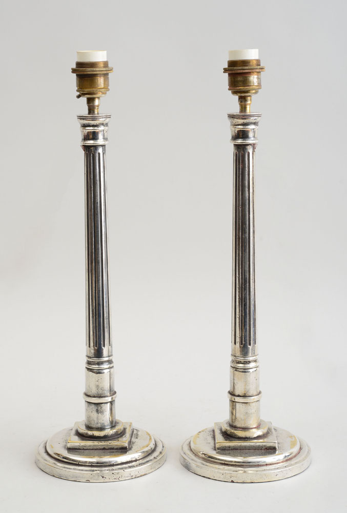 Appraisal: PAIR OF SILVER-ON-BRASS FLUTED COLUMN-FORM LAMPS On circular stepped bases